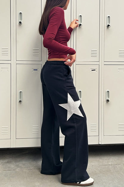 Wide-leg joggers with star | Subdued